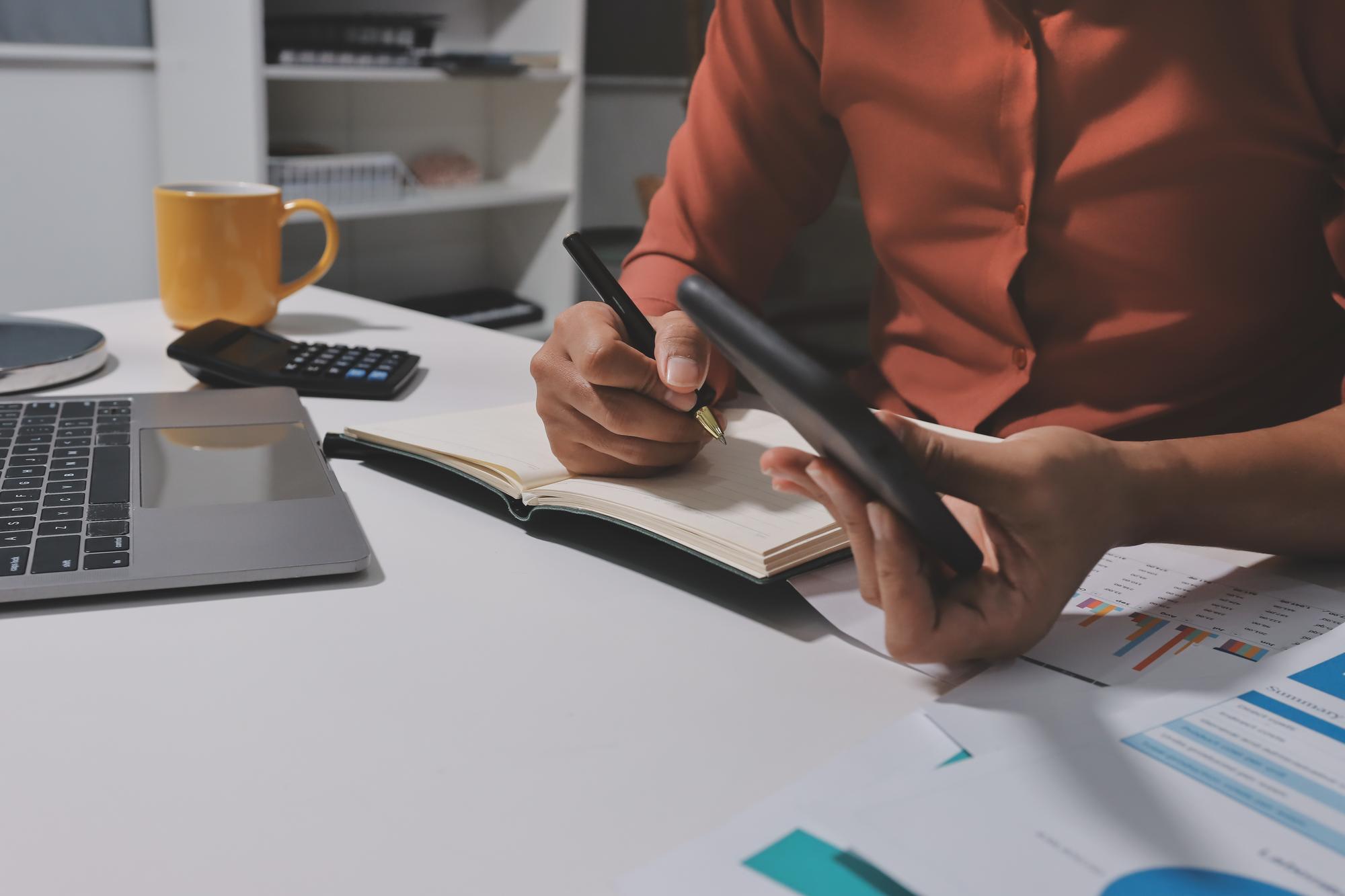 Person reviewing finances at desk